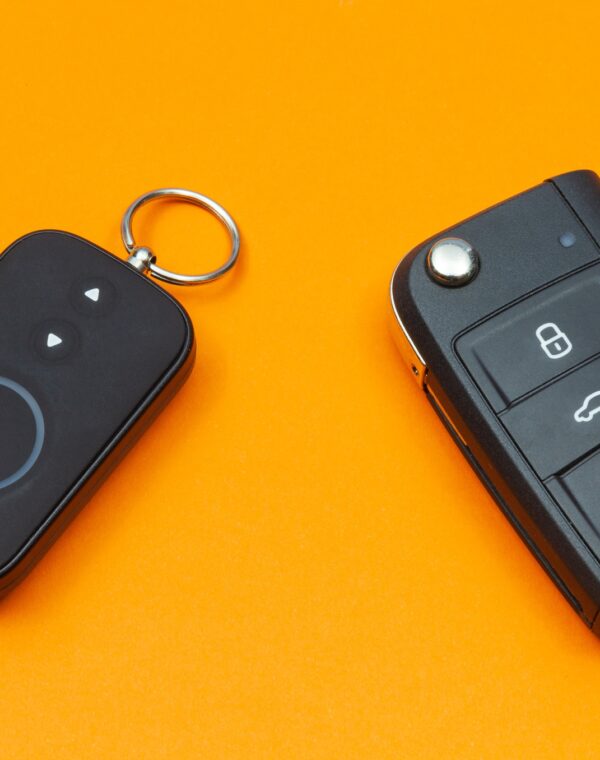 Car key with remote alarm control on the orange background