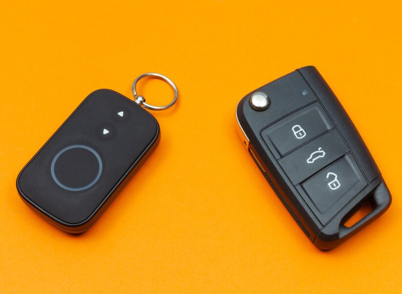 Car key with remote alarm control on the orange background